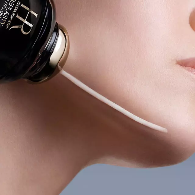 Helena Rubinstein Replasty Age Recovery Eye & Face Contour Concentrate applicator dispensing cream onto a woman's cheek.
