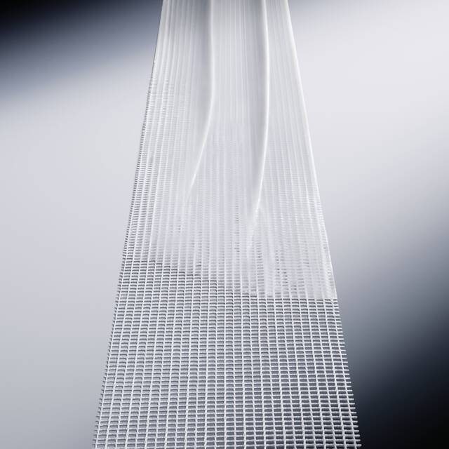 Smooth white cream texture gliding over a structured mesh band for advanced skin recovery.